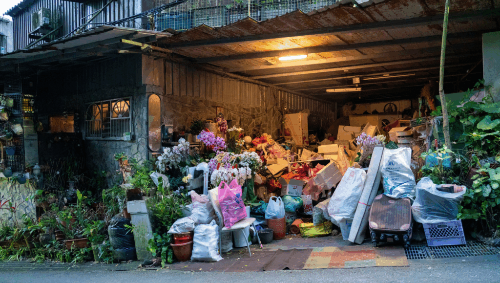 Interior of a hoarded commercial property, showing excessive clutter and debris that required commercial junk removal services.
