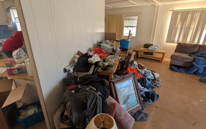 A cluttered room in a Tampa home filled with junk during a professional hoarder cleanout service by Site Masters.