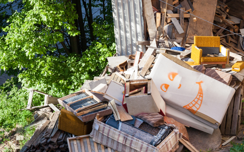 A massive pile of discarded furniture and wood debris in Tampa requiring a professional junk hauling service.
