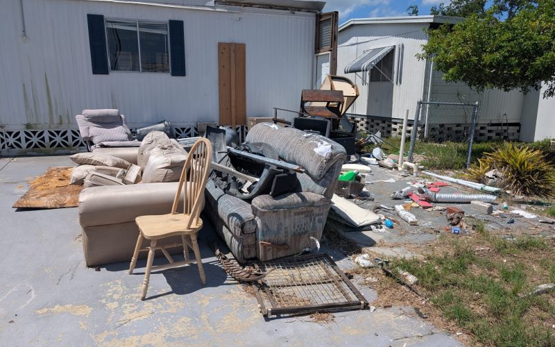 A pile of old furniture and junk on a driveway in Tampa waiting for our professional haul away service.