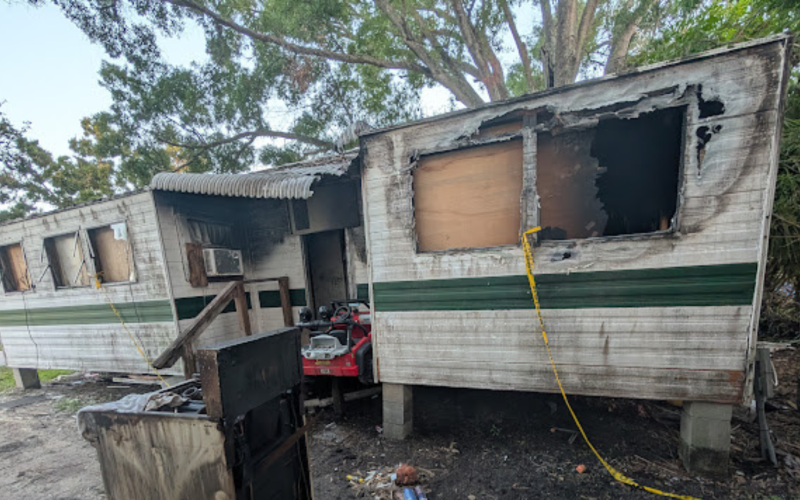 A fire damaged mobile home booked for a residential demo in Tampa Bay.